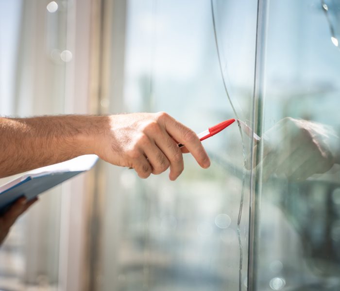 glass-broken-from-house-by-accident-man-checking-repair