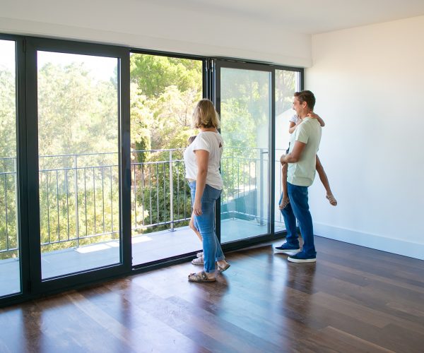 happy-family-with-kids-looking-balcony-smiling