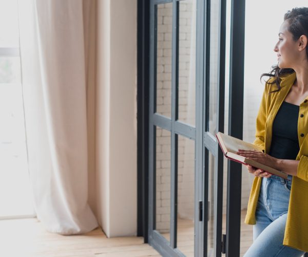 side-view-standing-woman-with-book